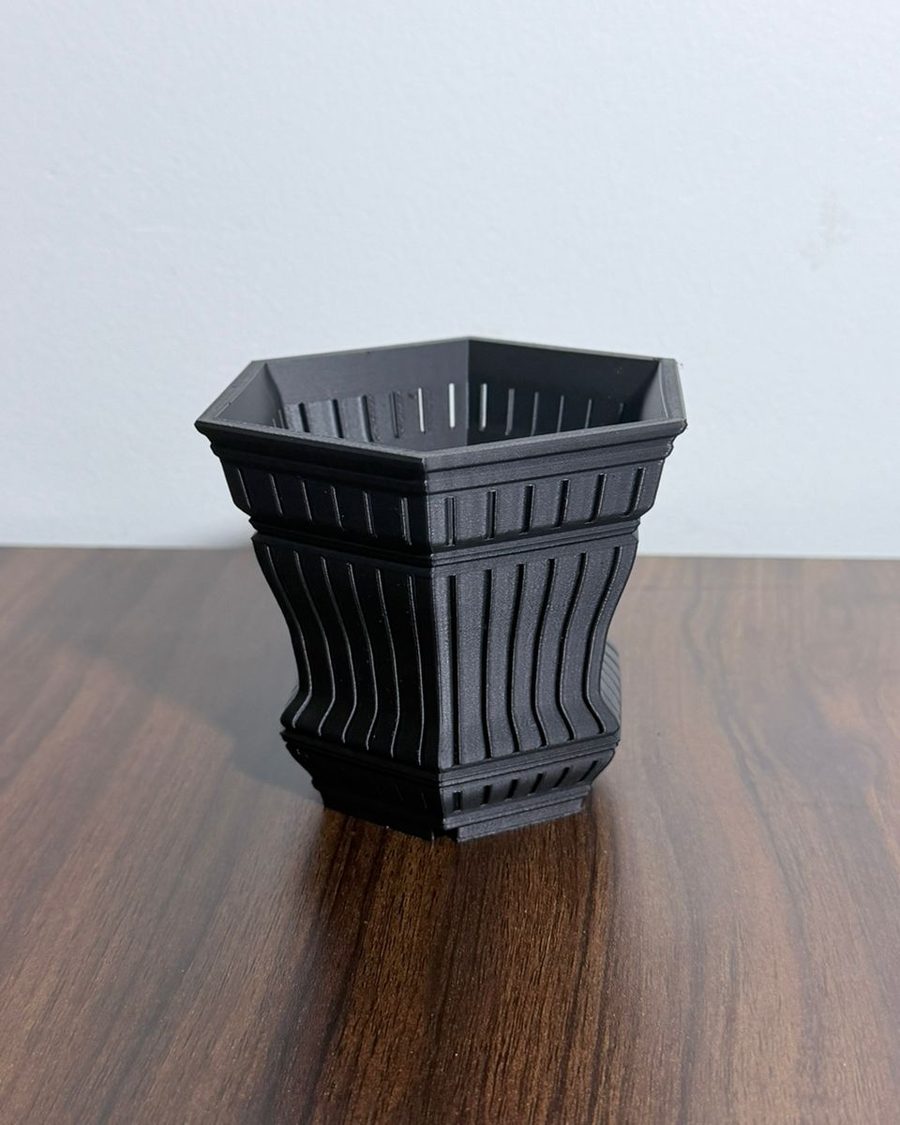 Six-sided black 3D-printed planter with vertical vent slots through the wall